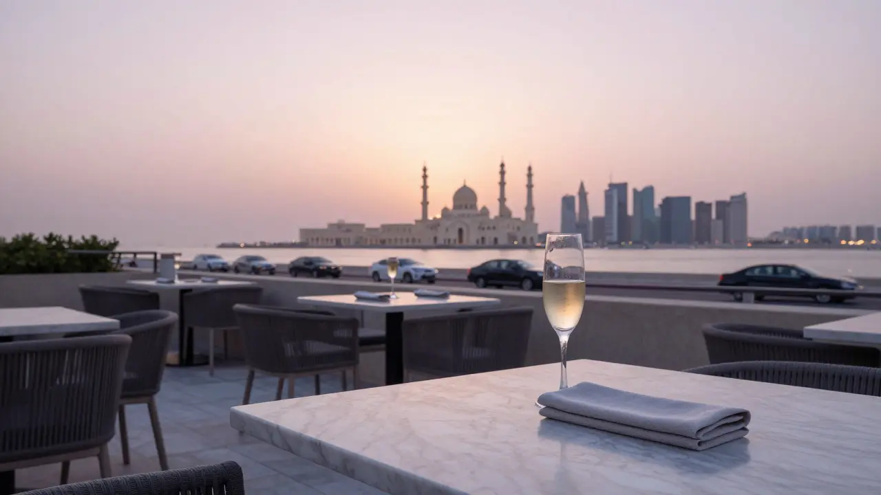 An empty rooftop lounge at dawn in Abu Dhabi, with a single champagne flute left on a marble table.