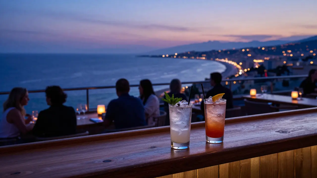 Rooftop bar view over Mediterranean coast at blue hour with cocktails.
