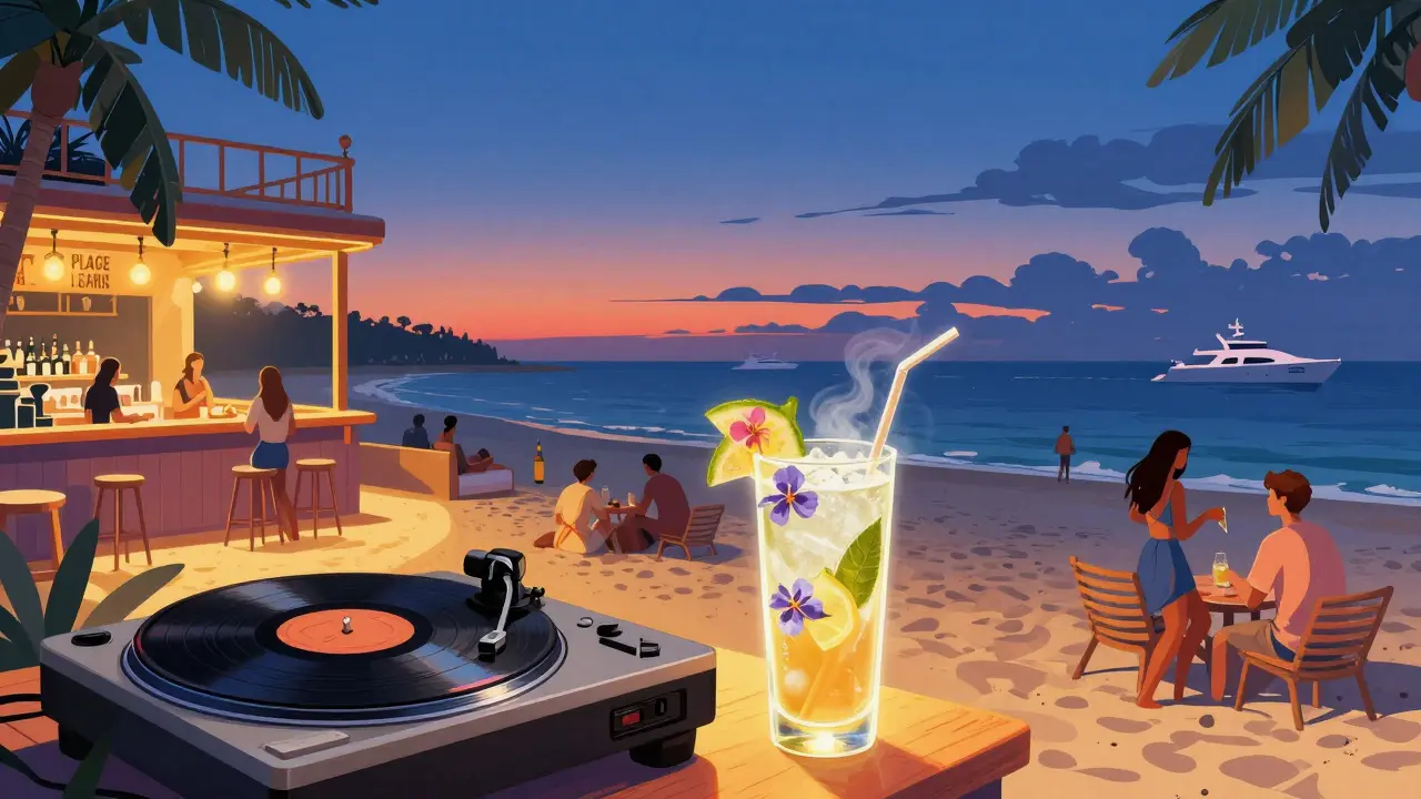 Rooftop beach party at La Plage as sunset turns to night, dancers barefoot on sand with vinyl records spinning.